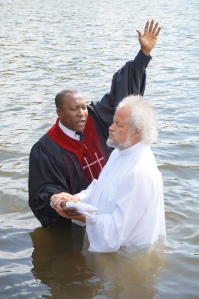 Husband getting baptized